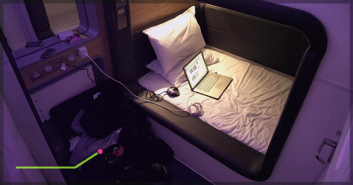 Compact hotel room with a laptop open on the bed