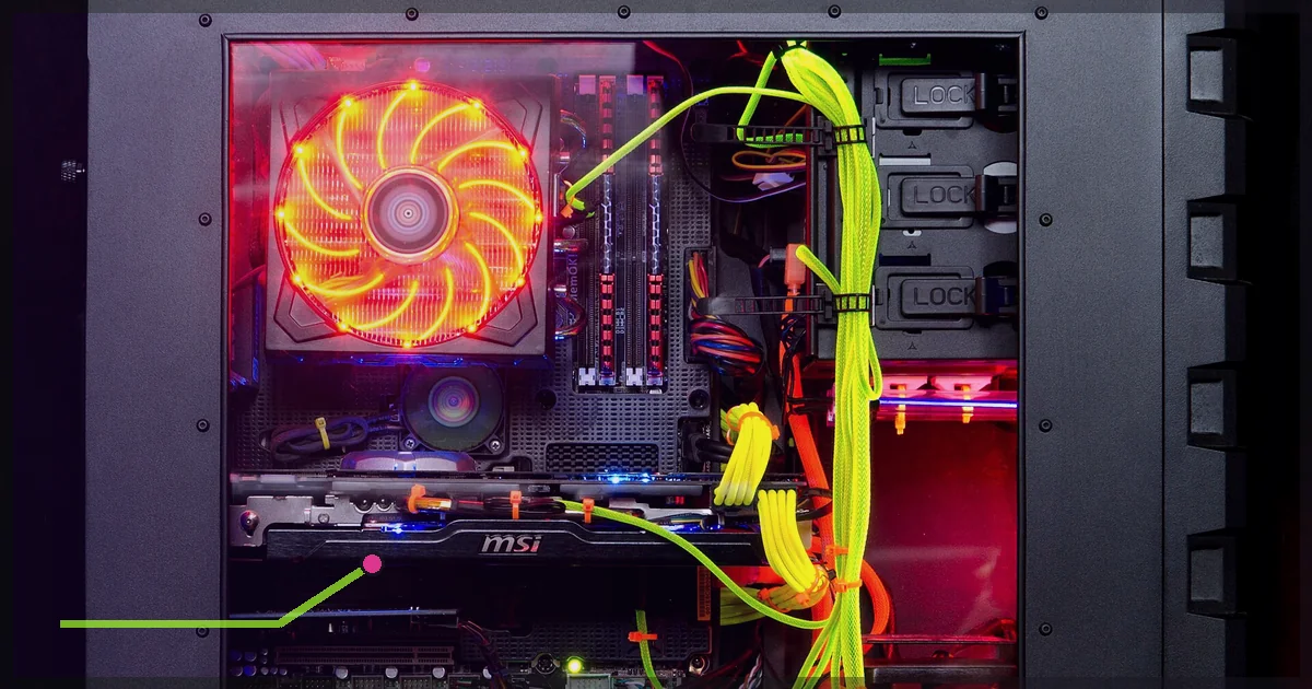 Open custom gaming PC with colorful cables and glowing cooling fan