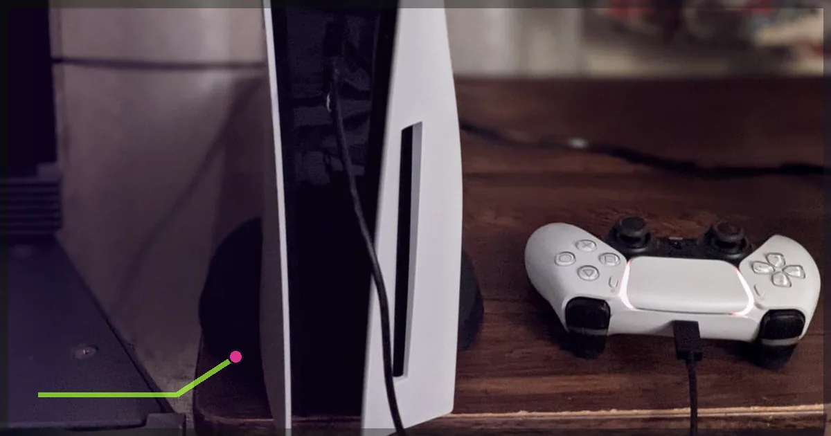 PlayStation 5 console and DualSense controller on a wooden surface