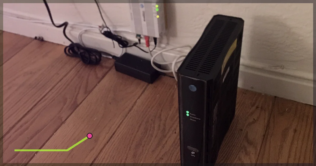 Home internet router installed beside cables and a wall outlet