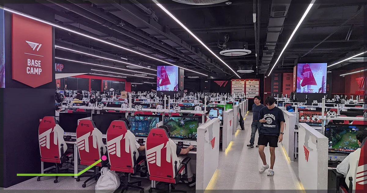 Large PC gaming center with rows of computers and gaming chairs